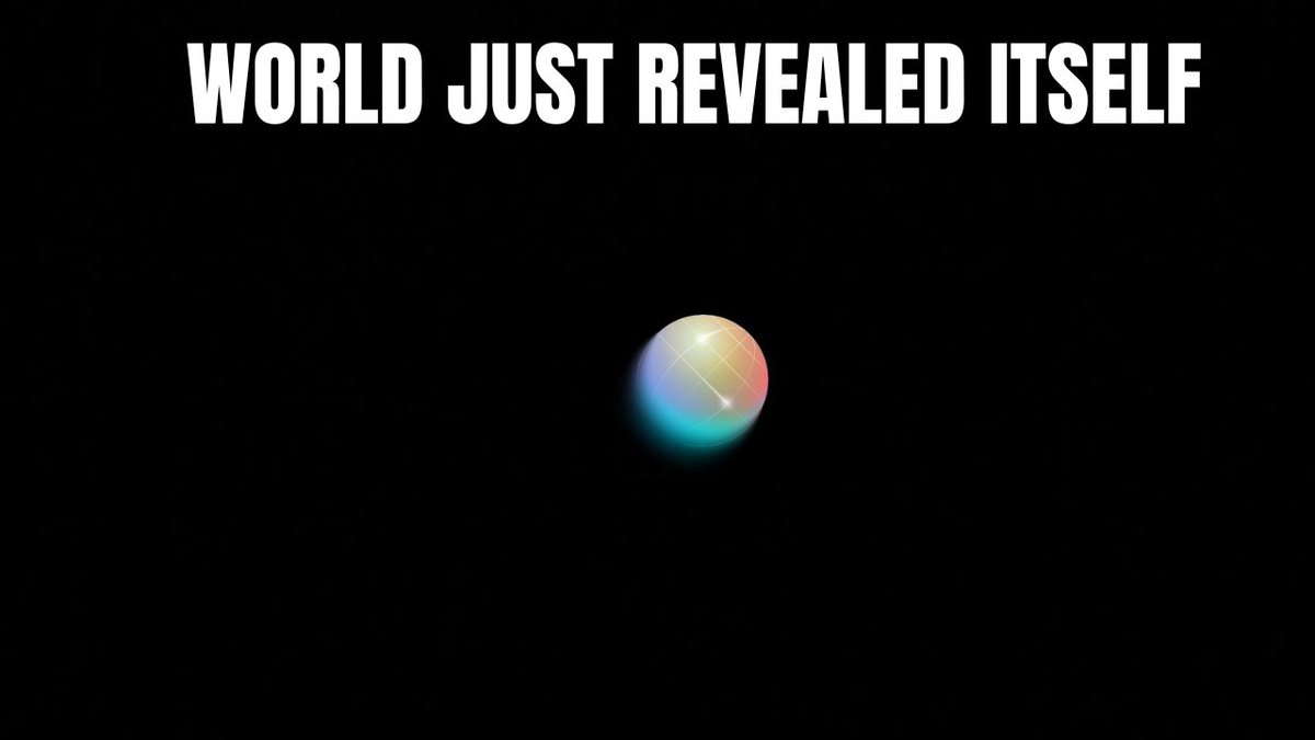 A black background with the bold white text 'WORLD JUST REVEALED ITSELF' above a small, colorful, iridescent sphere.