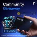 A promotional graphic for a 'Community Giveaway' featuring an Invertek hardware wallet and a Trezor wallet, offering a prize of 310 USDC.