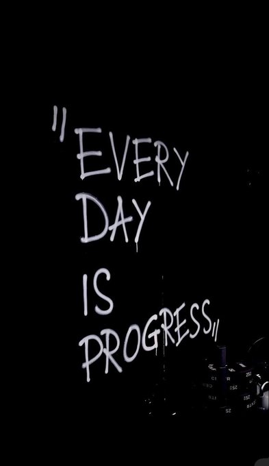 White handwritten-style text on a black background reads '"EVERY DAY IS PROGRESS"'.