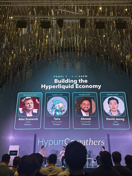 A conference stage at 'Hypurr Co...athers' featuring 'PANEL 1 - 1-1:30PM: Building the Hyperliquid Economy' with moderator Alex Svanevik (CEO, Nansen) and panelists Taha (Co-founder, Paragon), Ahmed (Co-founder, Outcome), and David Jeong (CEO, Treadfi).