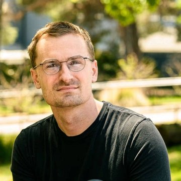 Jesse Pollak, creator of Base, pictured here in an outdoor portrait wearing a black t-shirt and glasses. The accompanying post features his commentary on tokenized equities and non-dollar stablecoins driving the next "tokenization supercycle."
