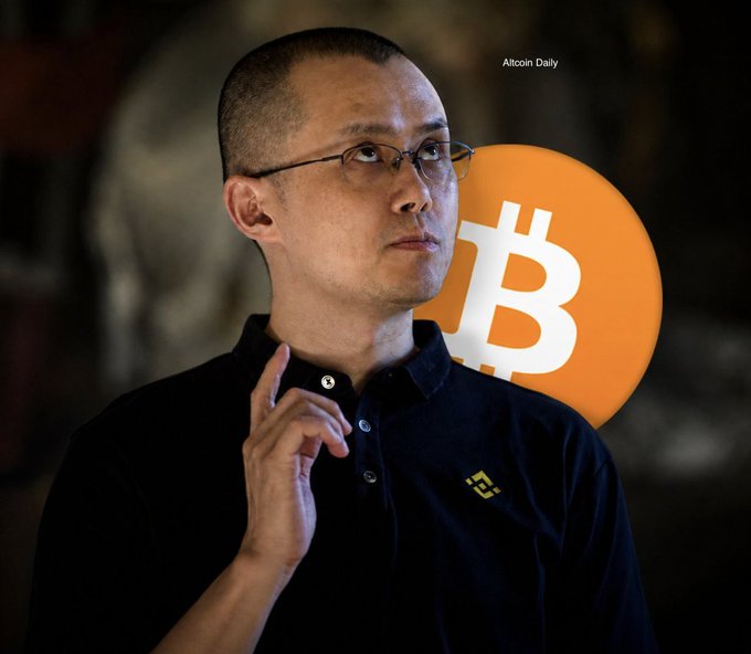 A man wearing glasses and a black polo shirt with a Binance logo, shown with a Bitcoin logo graphic beside him and 'Altcoin Daily' text in the corner.