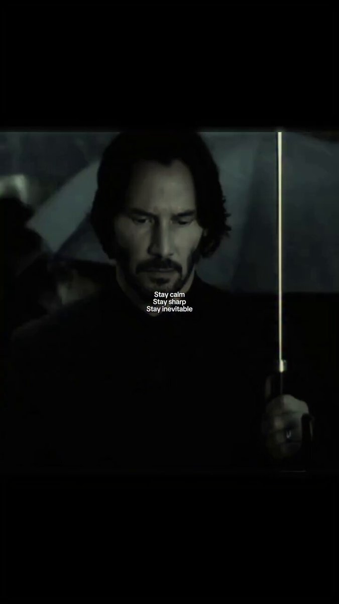 The image features a man with a beard holding an umbrella over his head. The background of the image is dark, which contrasts with the bright light shining through the umbrella. There are also some text elements present in the image that read "We're all feeling it", "There's a part in our wallets that' s crying It's normal", and "Always remember the rule Everyone loses Except for X analysts". The man holding the umbrella appears to be looking down, possibly contemplating something or reacting to an event.