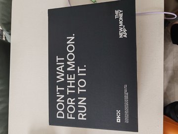 A black promotional box displaying the text 'DON'T WAIT FOR THE MOON. RUN TO IT.' along with 'NEW MONEY. NEW APES.' and an OKX logo.