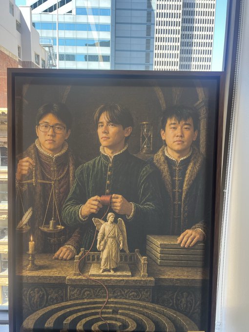 The image shows a framed Renaissance-style painting depicting three men in period clothing holding symbolic objects (scales, an hourglass, books, and a quill), with a small angel statue on a table. In the background, modern city skyscrapers are visible through a window, creating a striking juxtaposition between the classical artwork and contemporary urban setting. The painting appears to be promotional artwork for "GAMUT," whose logo is visible on one man's dark tunic, tying the Renaissance imagery to the post's theme of an "agents renaissance."