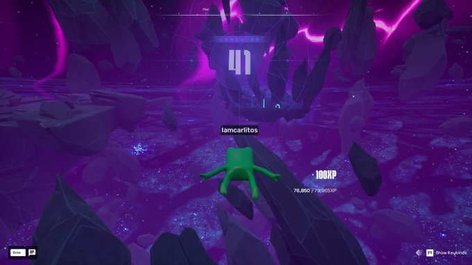 A video game screenshot showing a green character named 'iamcarlitos' floating in a purple space environment with floating rocks, displaying a score of 100KP and 79,850/79,865 XP.
