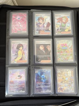 A binder page displays nine graded Pokémon cards arranged in a 3x3 grid, including what appear to be a holographic Mewtwo, trainer cards, and other Pokémon cards in protective slabs. The image relates to the post about tokenizing a complete master set of Pokémon cards, showcasing a portion of a graded collection that could potentially be digitized on platforms like Courtyard.io.