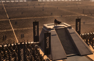 A figure stands atop a tall stone monument or staircase in a vast field, flanked by dark banners inscribed with golden text including the word 'SUNDAY'.