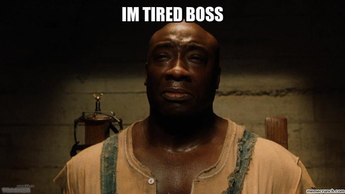 A meme image features a close-up of a tired-looking Black man with the bold white text 'IM TIRED BOSS' at the top, with a 'memecrunch.com' watermark.