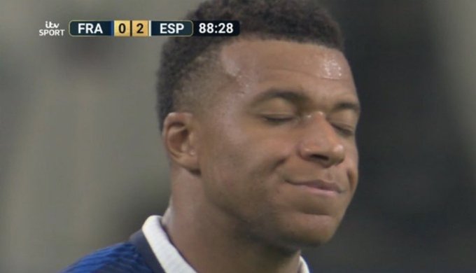The image appears unrelated to the post; it shows a close-up of a disappointed soccer player (Kylian Mbappé) during an ITV Sport broadcast of a match between France (FRA 0) and Spain (ESP 2) at 88:28. There is no visual connection to the advertised crypto product or payment service mentioned in the caption.