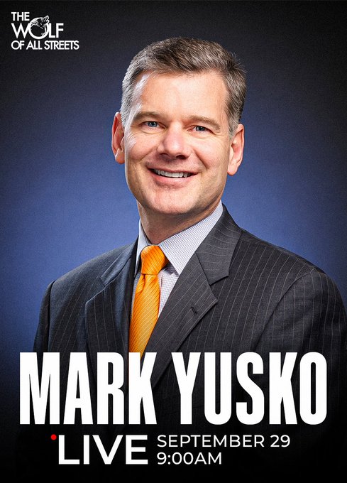 Promotional graphic for "The Wolf of All Streets" featuring Mark Yusko in a dark pinstripe suit with a bright orange tie against a blue gradient background, advertising his live appearance on September 29 at 9:00 AM, tying into the post about his discussion on Bitcoin's performance when interest rates were last this high.