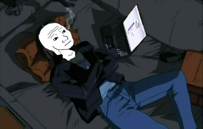 A figure lies back on a bed next to an open laptop, with a crudely drawn white face mask superimposed over their head featuring a smug expression.