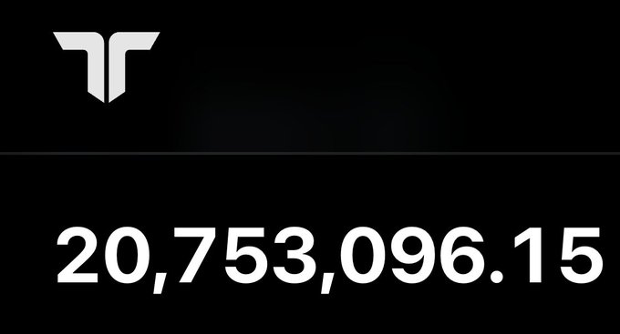 A minimalist black screen displays a stylized white logo in the upper left and a large counter showing the number '20,753,096.15' in white text.