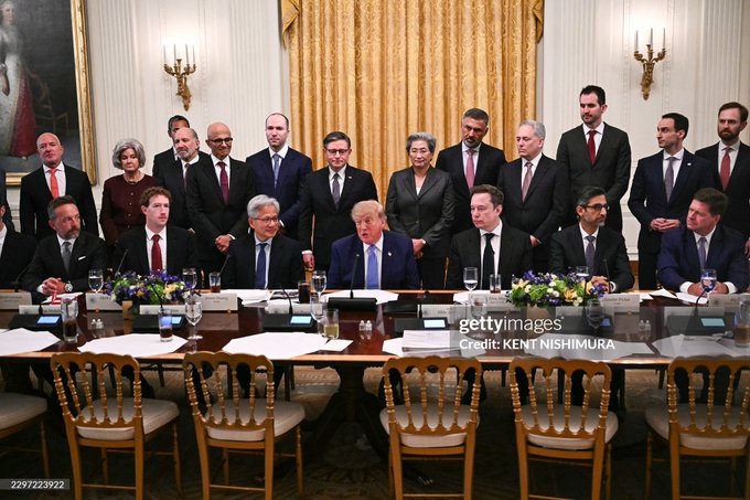 A formal meeting takes place in an ornate room with gold curtains, showing numerous officials seated and standing around a long table, with Donald Trump visible at the center; credit 'KENT NISHIMURA' appears on the image.