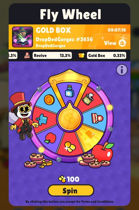A 'Fly Wheel' game interface featuring a 'GOLD BOX' for DropDedGorgez #3656, displaying a colorful spin wheel with various prizes, chances for Revive (13.3%) and Gold Box (0.33%), and a spin button costing 100 coins.
