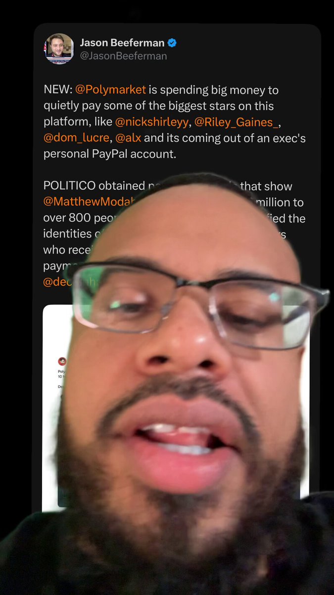 The image shows a man with glasses wearing a beard sitting in front of his computer screen displaying a message from Twitter. He appears to be a political commentator or an expert, as he has been tagged with the @POLYMARKET AT IT again. The post on Twitter is about Polymarket, an app that is being accused of charging conservative influencers for advertising. The man in the image seems to be sharing his thoughts and opinions about this issue.