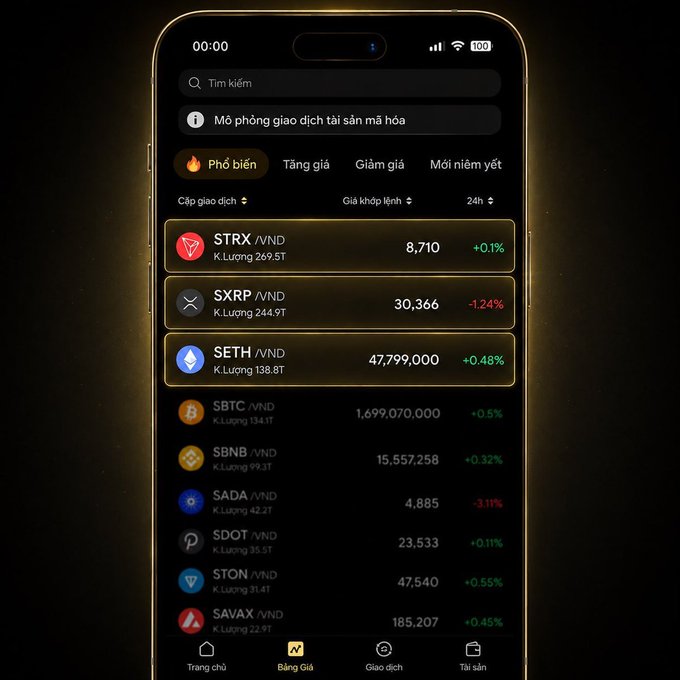 A smartphone screen showing a Vietnamese cryptocurrency exchange app with tabs for 'Phổ biến', 'Tăng giá', 'Giảm giá', listing coins like STRX, SXRP, SETH, SBTC, SBNB, SADA, SDOT, STON, and SAVAX with their VND prices and 24h changes.