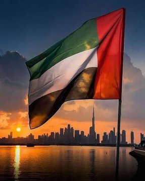 The image features the UAE flag waving prominently against a sunset skyline of Dubai, including the iconic Burj Khalifa, with the city's silhouette and water reflections visible in the background. This visual ties directly to the post's topic, as it highlights Dubai's legal landscape—specifically the Dubai court's ruling that cryptocurrency can be included as part of an employee's salary if contractually specified, while base pay in AED through the Wage Protection System (WPS) remains mandatory, meaning full Bitcoin salaries are not sanctioned.