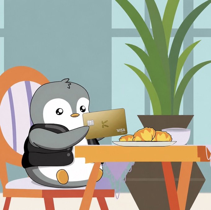 The image features a cartoon penguin sitting at a dining table with a plate of pastries, including croissants. The penguin holds a credit card or Visa gift card in its beak while seated at the table. The scene takes place indoors, possibly in an office setting, as there is a chair and a potted plant nearby.

The post discusses the issue of hidden fees associated with credit cards, specifically focusing on foreign transaction fees (FX fees). These fees can eat away at users' spending power over time, making it essential to be aware of such costs when using credit cards for international purchases or online transactions. The post also mentions that KAST's new 0% FX promotion is designed to help users save money by reducing these hidden costs.