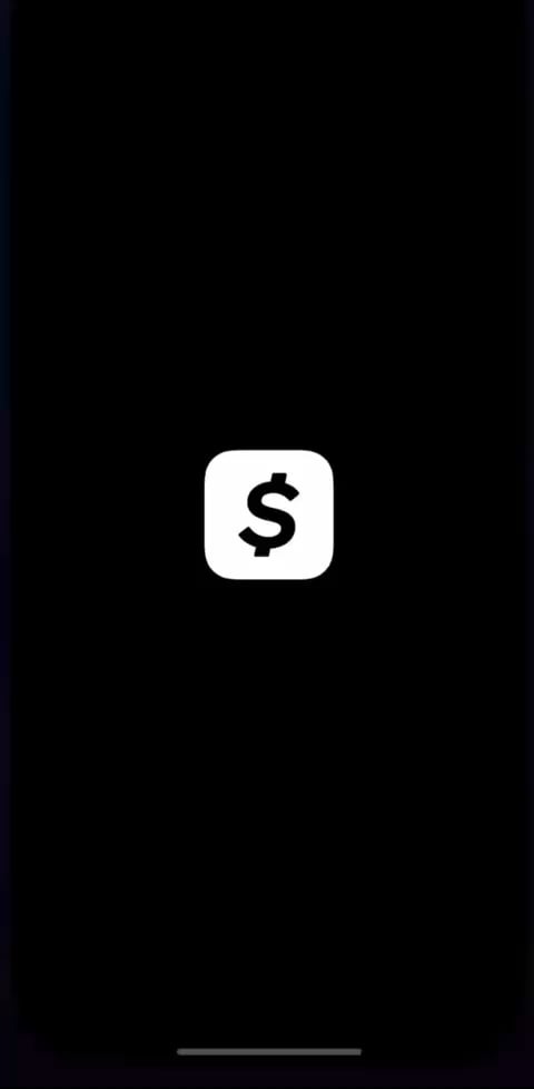 The image shows a black smartphone screen with a white dollar sign symbol, which indicates that the app supports USDC payments. This means that users can send or receive money through the app using USDC (United States Digital Currency). The presence of this feature suggests that the app is designed to facilitate secure and fast transactions for users who want to pay in USDC.