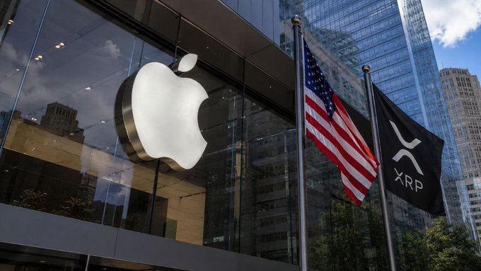 iphone store front with a large white apple logo, accompanied by two flags - an American flag and a Bitcoin symbol.
