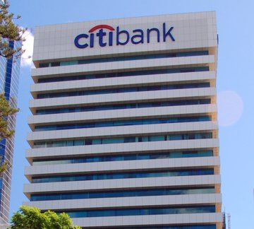 The Citibank headquarters building is shown with its prominent "citibank" logo atop the modern high-rise, visually representing the financial institution referenced in the post as the "$2 trillion banking giant" making a bullish Bitcoin price prediction. The towering corporate office building reinforces the credibility of the bank's market outlook.