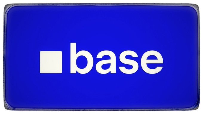 A bold blue sign displays the "base" logo featuring a white square alongside the word "base" in lowercase white text. The image serves as the official branding for the Base blockchain network, visually anchoring the post's message about the platform's impressive metrics—$424.5M DEX volume, $252.1M perps volume, 278K+ active addresses, and $1.02M app fees—highlighting its sustainable growth over fleeting narratives.