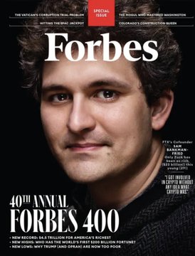 A Forbes magazine cover featuring a portrait of a man in a dark jacket, promoting the "40th Annual Forbes 400" with headlines about Bitcoin reaching $7.1 trillion of America's wealth and FTX's cofounder Sam Bankman-Fried.
