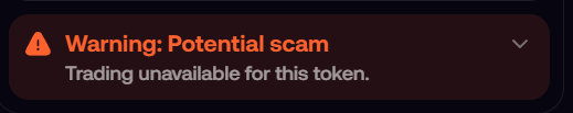 A warning banner with an orange alert icon stating 'Warning: Potential scam - Trading unavailable for this token.'