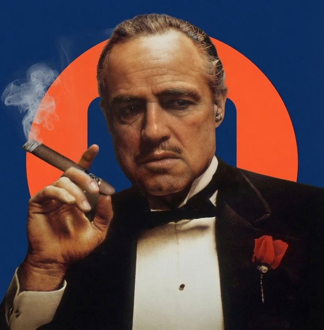 A portrait of a man in a tuxedo smoking a cigar, set against a blue background with a red circle and a blue shape, evoking the iconic style of The Godfather's Don Vito Corleone.