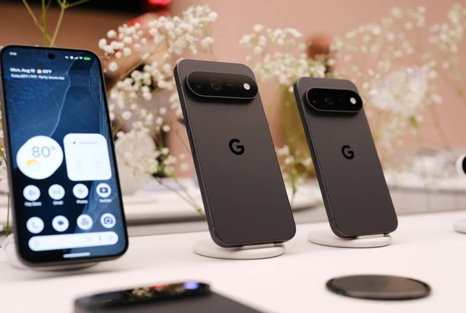 A new Google Pixel smartphone displays its home screen with weather showing "80°" and the date "Mon, Aug 11," while two additional Pixel devices in dark gray showcase the iconic "G" logo on their backs, all set against a floral backdrop. The image visually supports the post's narrative about Google Pixel 11 preorders, highlighting the devices' on-device AI capabilities that could power future onchain micro-transactions through increasingly capable mobile chips.