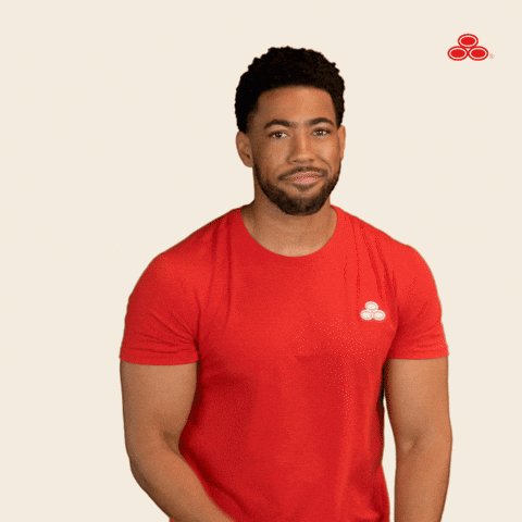 The image features a man wearing a red t-shirt, standing against a white background with his hands on his hips. He has a serious expression on his face as he looks directly at the camera. The caption of the image reads "ton bag holders about to farm hell itself huh". This phrase is written in all capital letters and is positioned above the man's head, emphasizing the seriousness of the situation or statement being conveyed by the image.