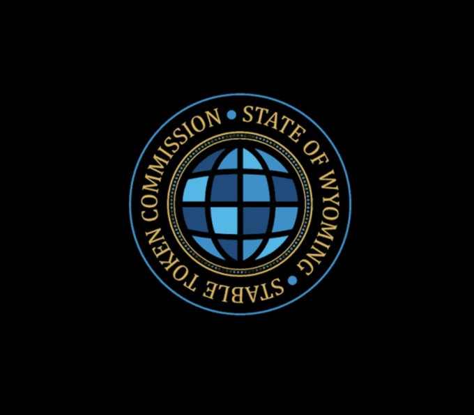 The image displays the official seal of the Stable Token Commission State of Wyoming, featuring a blue and gold globe design encircled by the commission's name. This emblem represents the regulatory body responsible for overseeing Wyoming's Frontier Stable Token, which has been migrated to Chainlink CCIP for enhanced security.