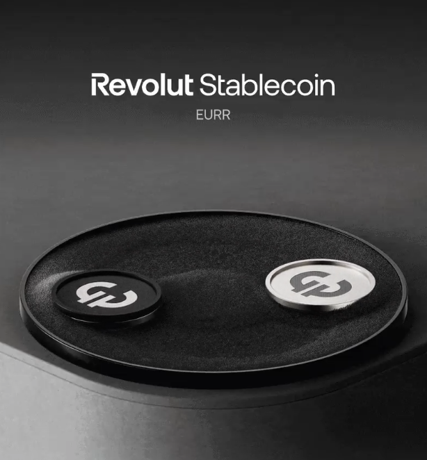 The image features two physical tokens displayed on a dark circular platform, with text above reading "Revolut Stablecoin" and "EURR". Each token bears the stylized "R" emblem of Revolut—one finished in matte black and the other in brushed silver—visually representing the launch of Revolut's new euro-backed EURR stablecoin.