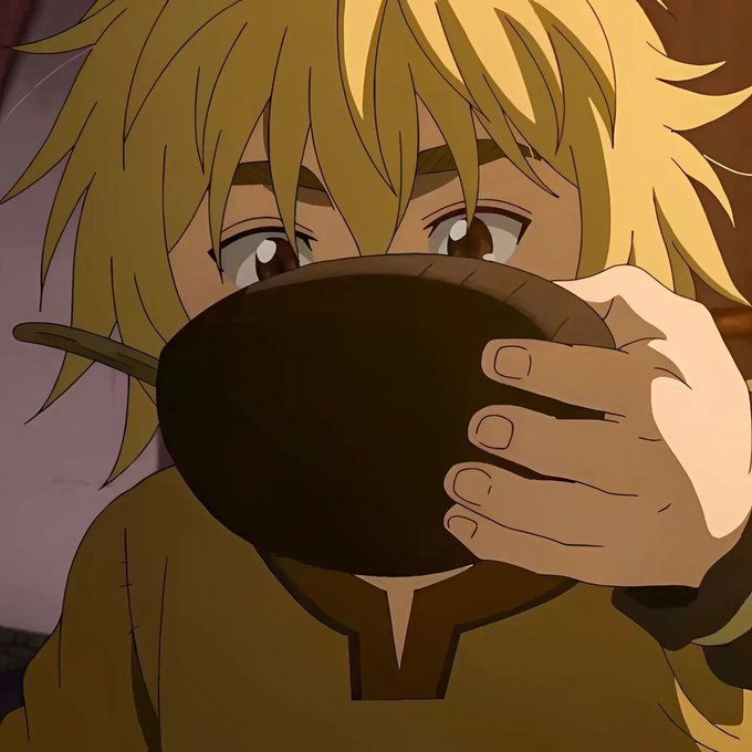 An anime-style illustration showing a close-up of a blonde-haired character with large eyes holding a dark bowl up to their face, obscuring their mouth and nose.
