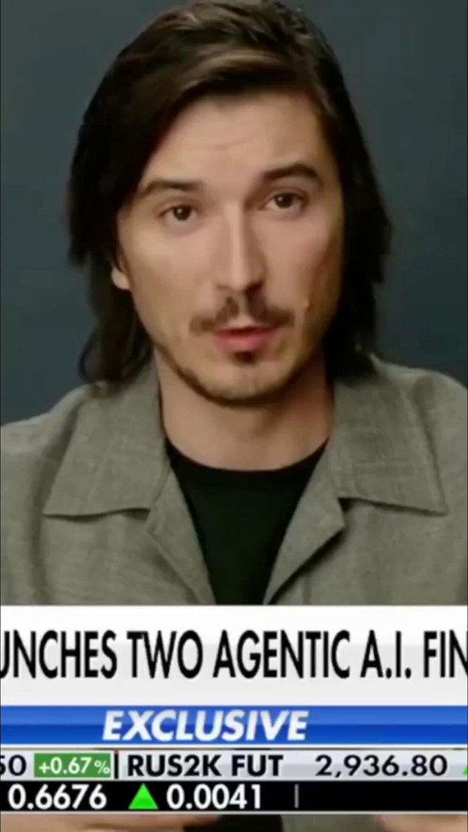 The image features a man wearing a gray jacket standing against a blue background, looking directly at the camera. The text "Vlad Tenev announces agentic trading accounts" can be seen in the image as well. The main focus of the image is on the man and his facial expression, with no other objects or people visible.