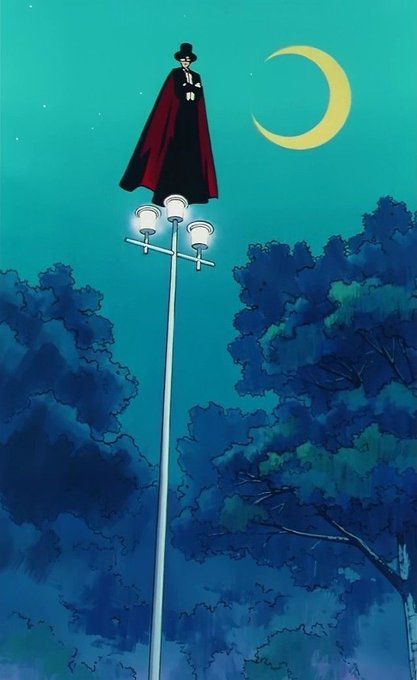An anime-style illustration shows a figure in a black suit, top hat, and red cape standing atop a tall lamppost under a crescent moon in a night sky above a dark forest.