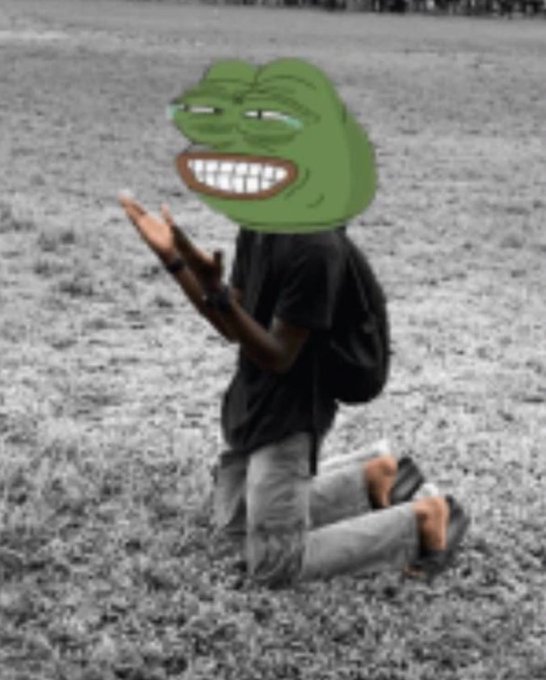 A desaturated photo shows a person kneeling on rocky ground with hands raised in a celebratory pose, their face replaced with the grinning, crying "troll face" meme.