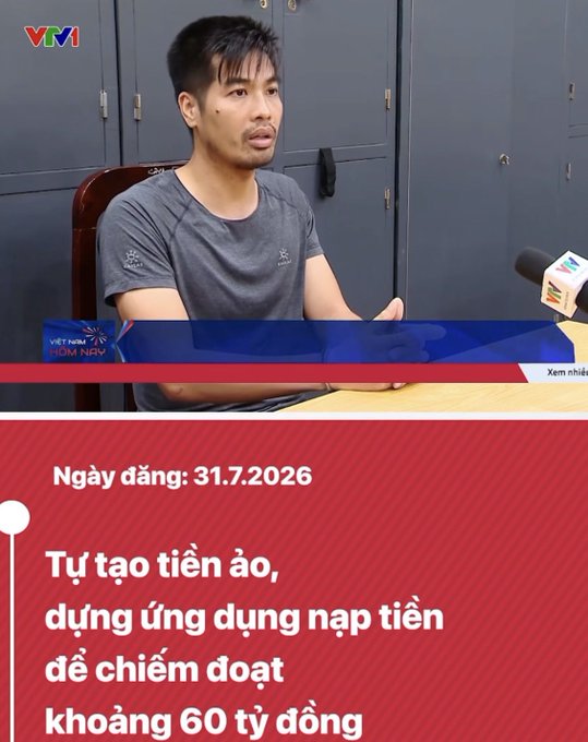 A Vietnamese news broadcast from VTV1 shows a man being interviewed. The red banner at the bottom reads: 'Ngày đăng: 31.7.2026', 'Tự tạo tiền ảo, dựng ứng dụng nạp tiền để chiếm đoạt khoảng 60 tỷ đồng'.
