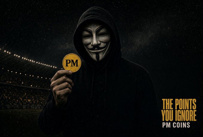 A dark promotional image features a hooded figure wearing a Guy Fawkes (Anonymous) mask, holding up a gold coin marked 'PM' against a stadium backdrop, with the tagline 'THE POINTS YOU IGNORE / PM COINS'.