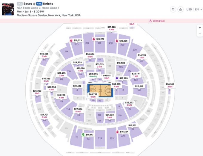 The image shows a large circular seating area with purple seats, possibly at a basketball game or arena. The seating arrangement includes multiple rows of chairs, indicating that this venue can accommodate a significant number of spectators. A map of the event space is displayed on the screen, providing information about the layout and seating options for attendees.