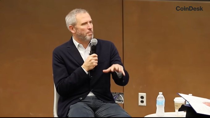 Ripple CEO Brad Garlinghouse speaks at the University of Kansas Business School, likely addressing the company's consideration of shutting down following the SEC's 2020 lawsuit and potential dissolution of its XRP holdings, as indicated by the CoinDesk watermark in the corner.