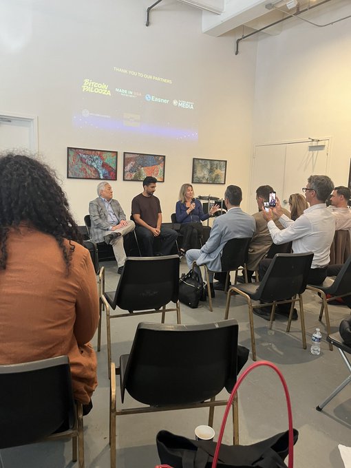 An audience sits in a gallery watching a panel discussion, with a projection on the wall reading 'Steady Palooza' and 'THANK YOU TO OUR PARTNERS' alongside logos for Made in Japan, Esner, and Media.