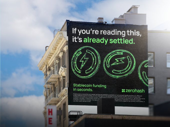 A billboard on a building advertises Zerohash, a stablecoin funding service, with the tagline 'If you're reading this, it's already settled' and 'Stablecoin funding in seconds.'