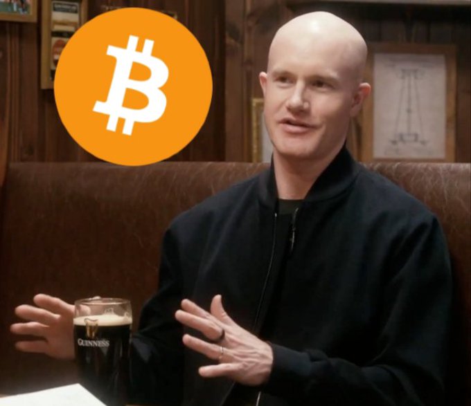 A bald man wearing a black jacket sits in what appears to be a pub or restaurant, gesturing during what looks like an interview, with a glass of Guinness beer visible on the table in front of him. A large orange Bitcoin (₿) logo is overlaid in the top-left corner of the image. The image appears to reference Brian Armstrong, CEO of Coinbase, whose discussion of using Bitcoin as real-world collateral for major purchases like home down payments aligns with the accompanying post about crypto adoption.