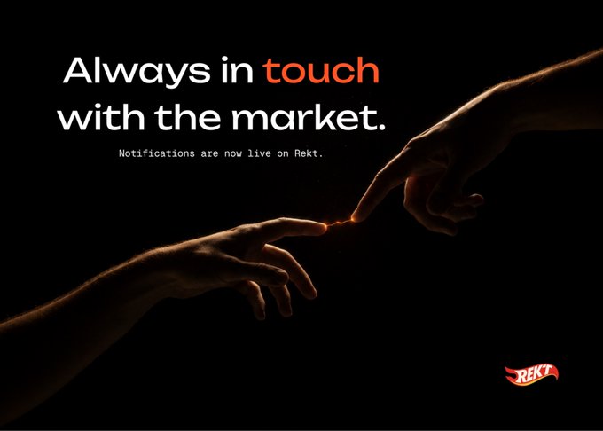 A dark advertisement showing two hands reaching toward each other like in Michelangelo's 'Creation of Adam', with the text 'Always in touch with the market. Notifications are now live on Rekt.' and the REKT logo.