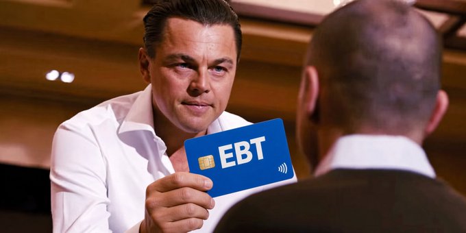 A photo of Leonardo DiCaprio holding up a blue 'EBT' (Electronic Benefit Transfer) card toward another man, appearing to be a digitally edited or AI-generated image.