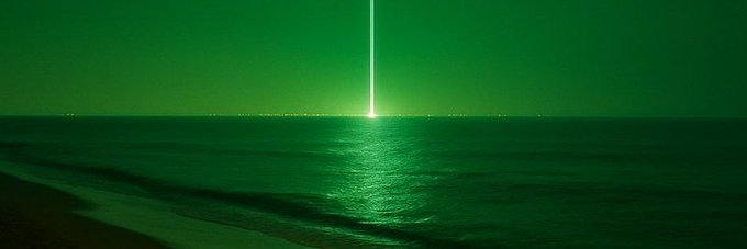 A green-tinted nighttime seascape features a single bright beam of light piercing vertically from the horizon, reflecting across the calm ocean waves. The image evokes the post's sense of singular optimism, visually representing the "$CORE" cryptocurrency as a lone guiding light against an otherwise dark and uncertain crypto market horizon.