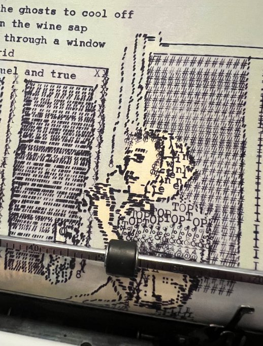 A close-up of a typewriter page where the keys have jammed, creating an abstract pattern of overlapping characters over a poem with visible lines like 'the ghosts to cool off' and 'through a window'.