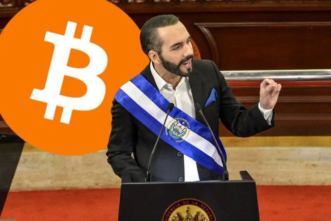 A man wearing a formal black suit with the El Salvador presidential sash, speaking at a podium, with a large Bitcoin logo overlay on the left.